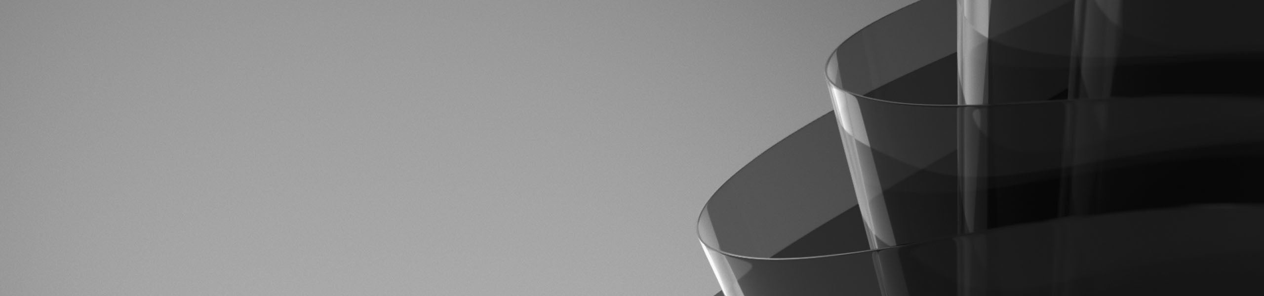 Close-up of a reflective black surface with a blurred background